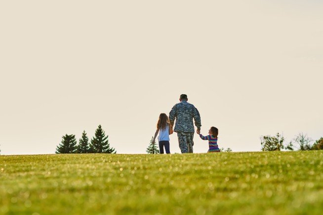 soldier-with-two-little-girls-walking-forward-bac-2024-09-17-09-56-33-utc-1.jpg