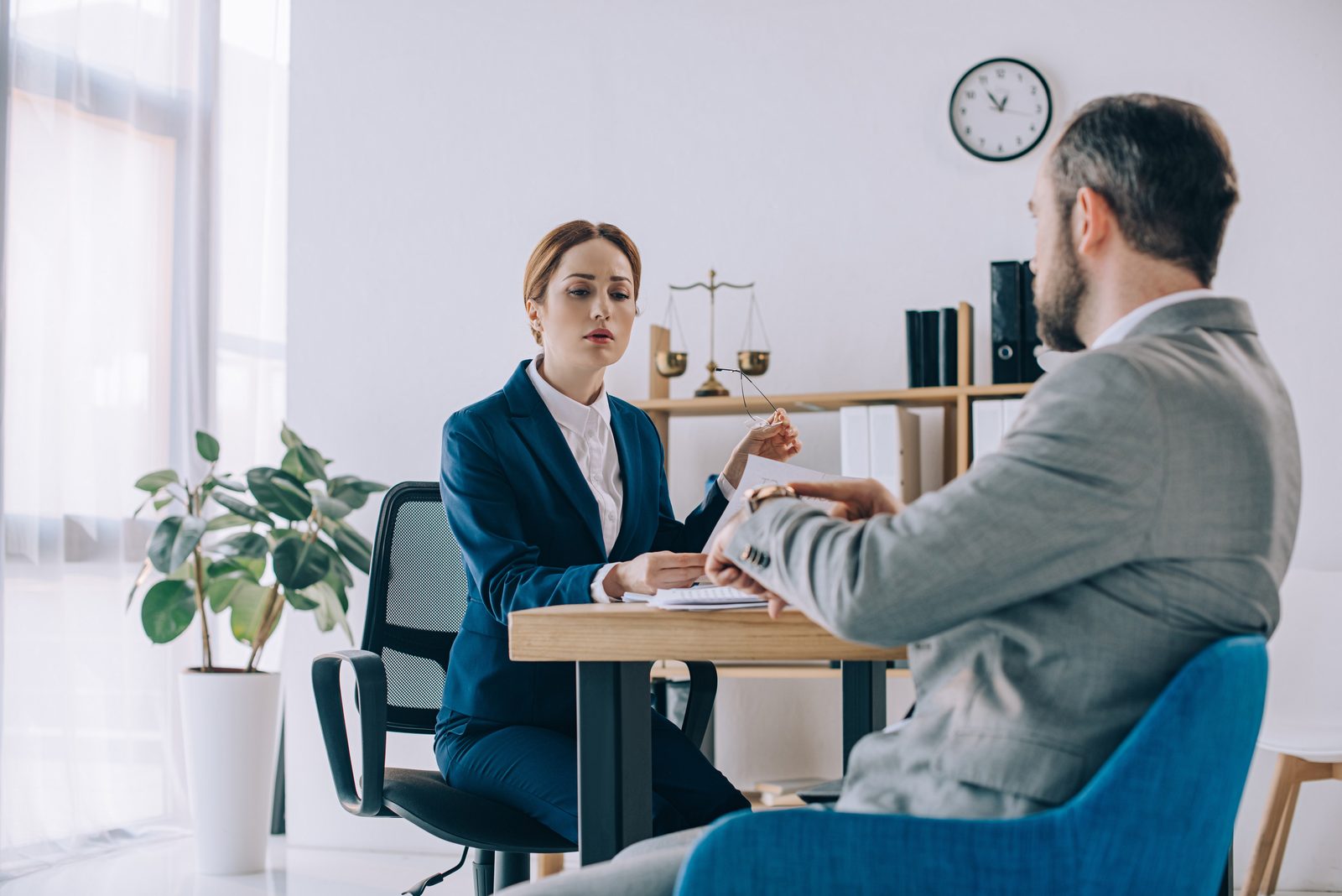 Attorney and client reviewing paperwork together in an office meeting