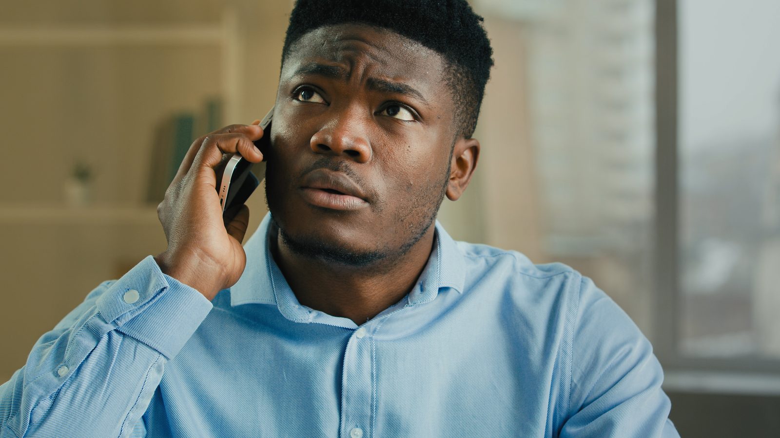 Man on the phone with a concerned expression