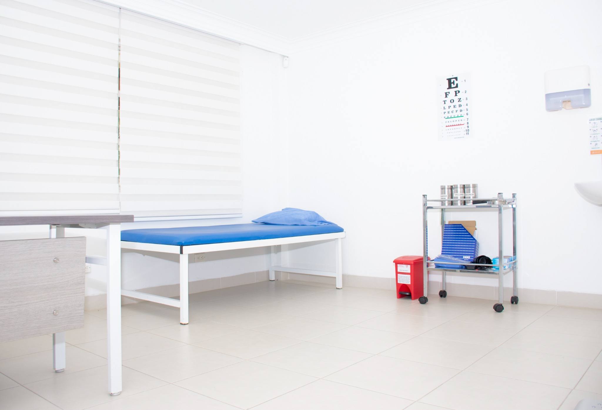 Empty medical examination room with paper-covered table, representing a defense-ordered IME in a California injury claim