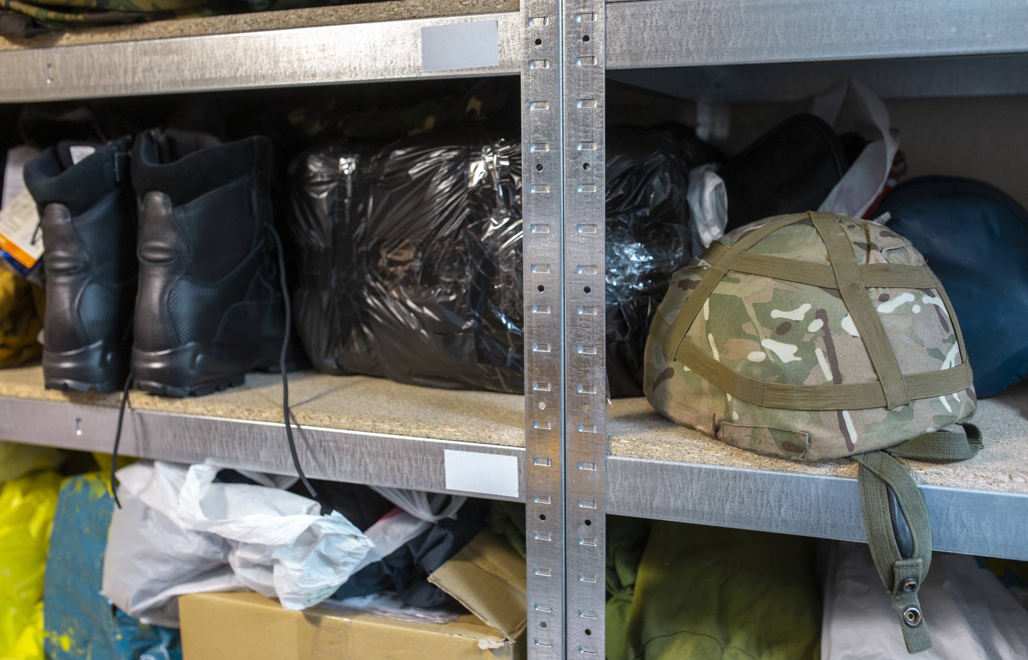 Military uniform jacket beside a stack of medical records, representing a service member's pre-existing condition in an injury claim