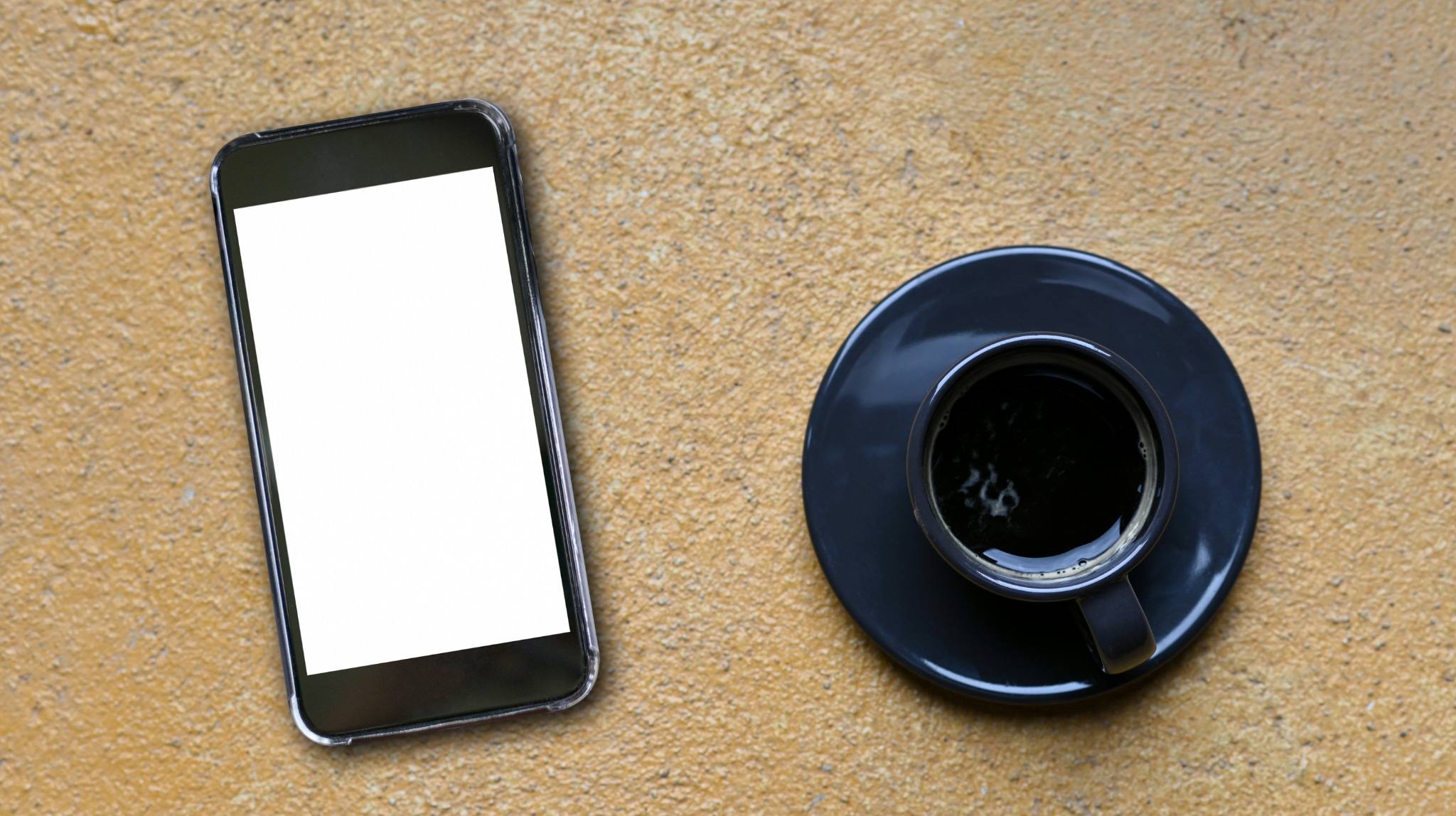 Smartphone lying face-down on a table, representing social media caution during an open injury claim