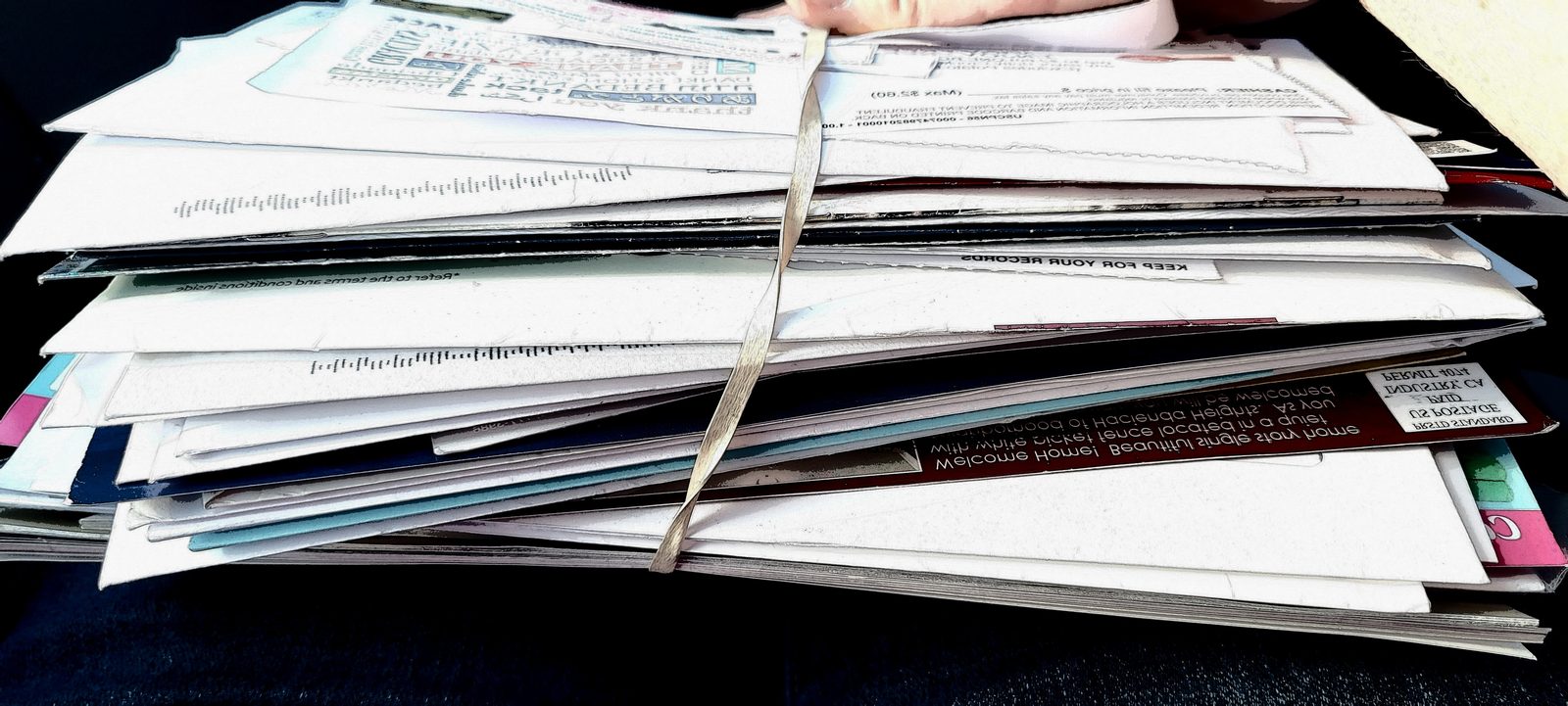 Stack of unpaid medical statements next to an auto policy declarations page